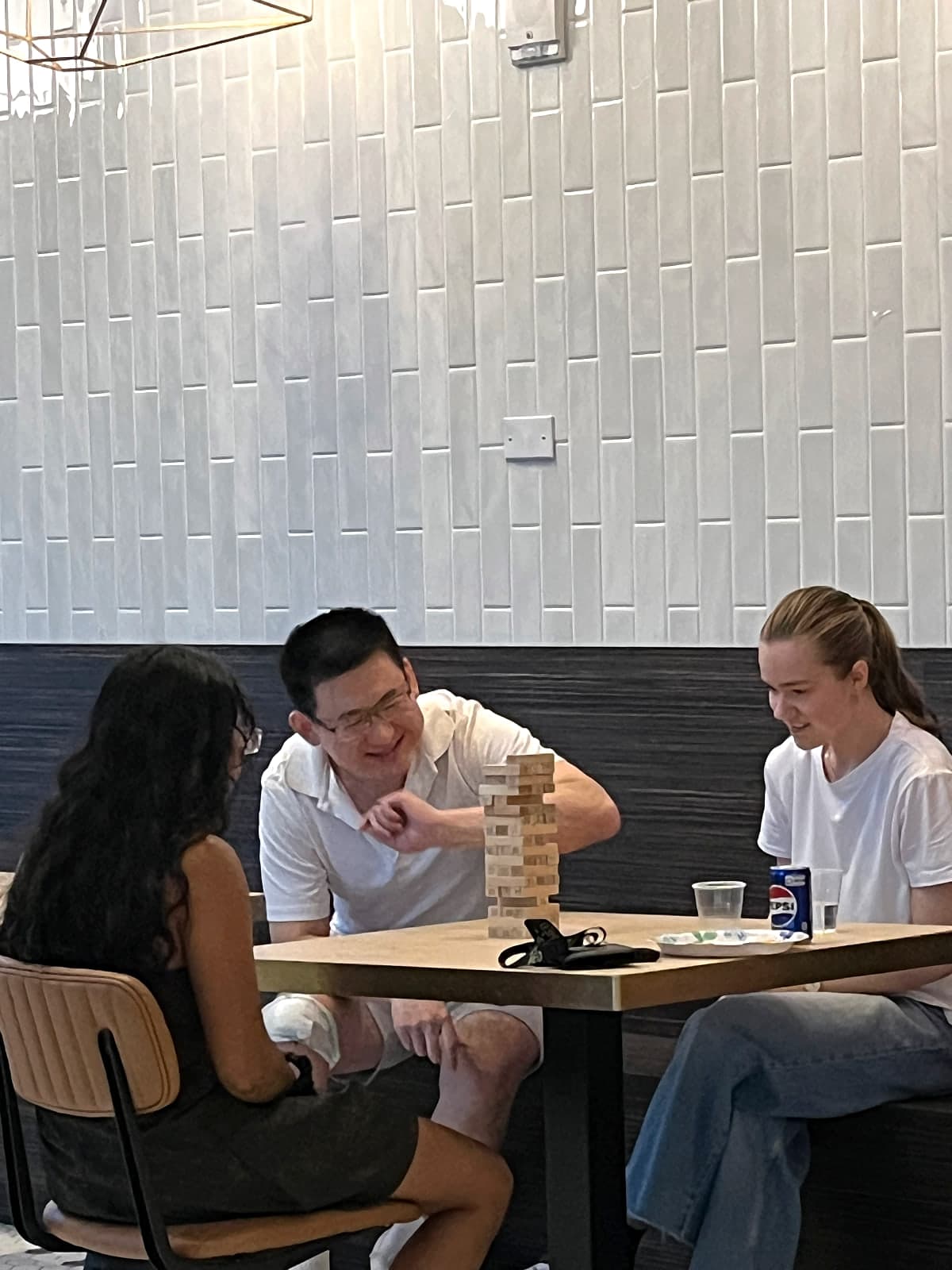 Residents laughing over a Jenga tower at the Theo Ottawa games tournament
