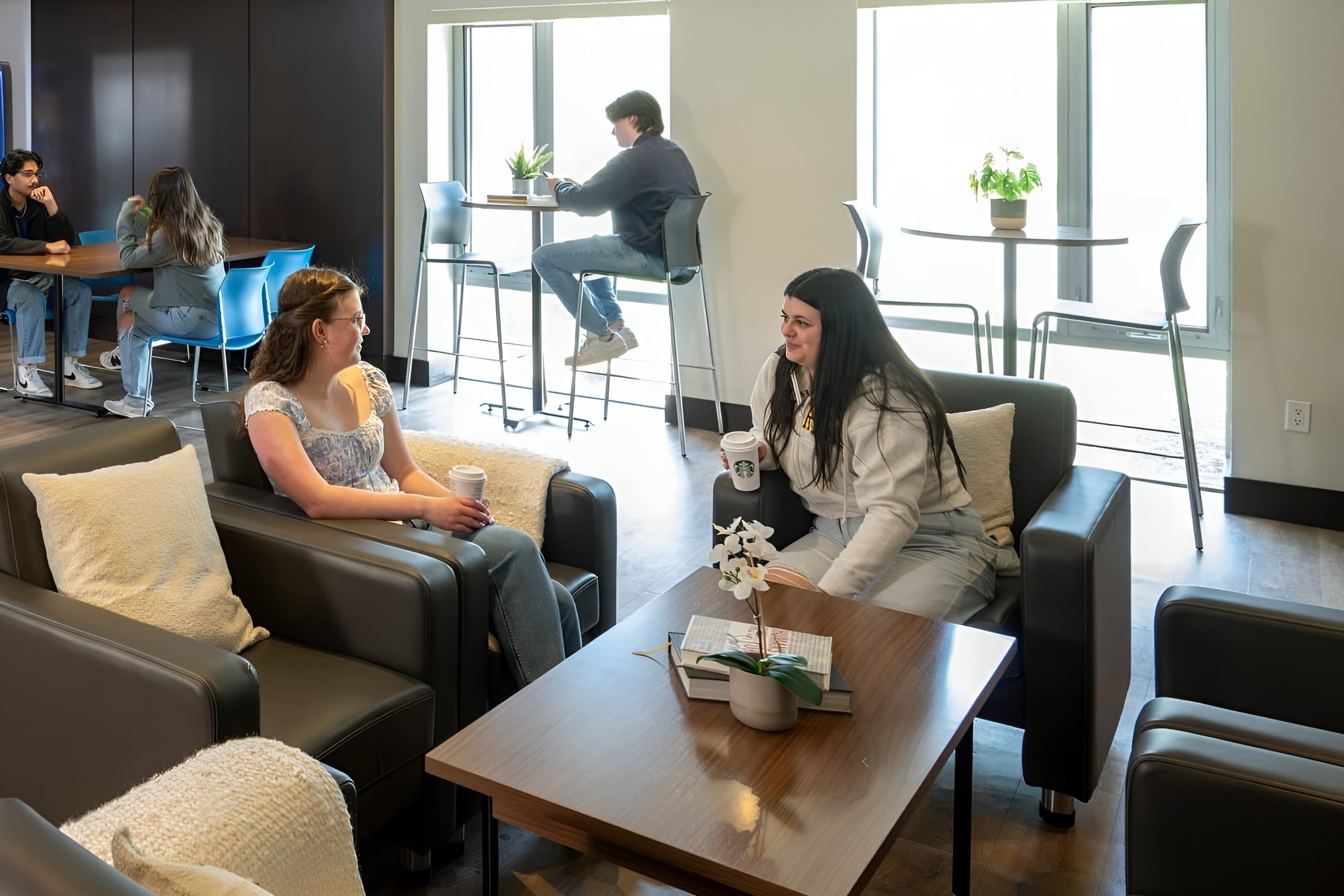 Residents relaxing in a Canadian Student Living lounge