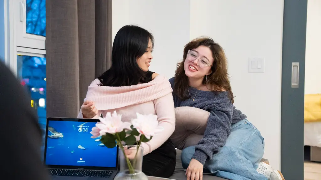 Student relaxing in a furnished bedroom suite