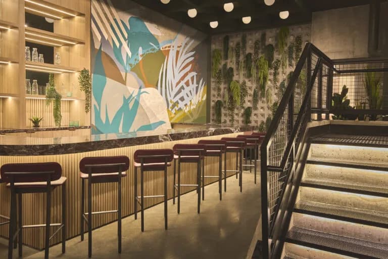 Bar seating under a painted feature mural