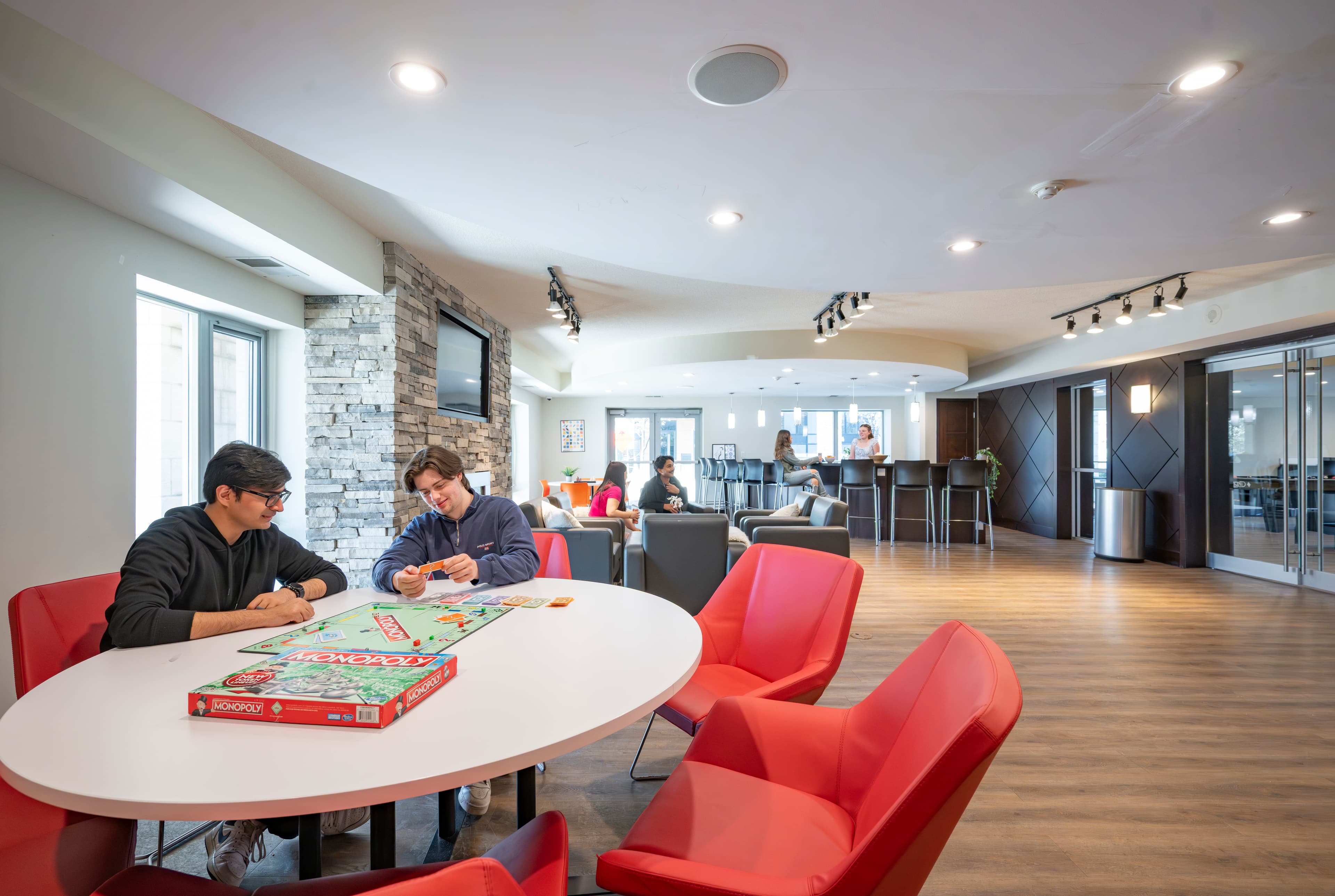 Students in modern communal lounge at King Street Towers