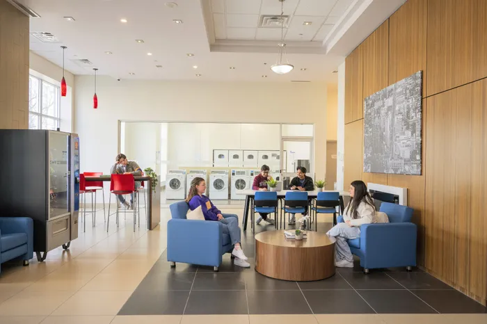 Modern communal lounge with vibrant seating and bright lighting