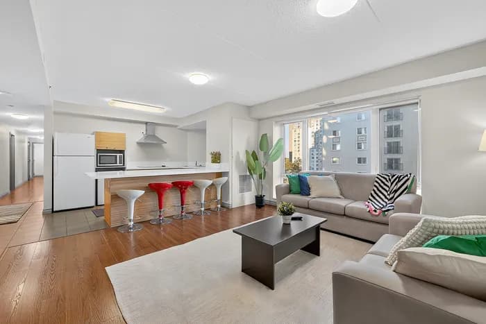 Contemporary open-plan living area with chic kitchen and cozy seating